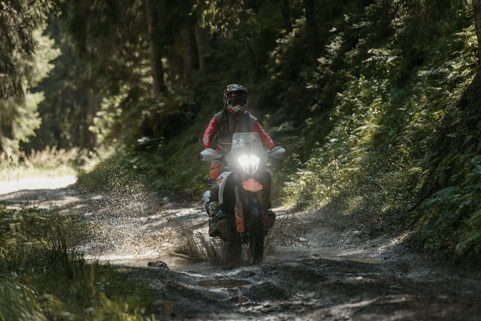 KTM motorcycle water crossing forest trail Romania adventure rally 2025