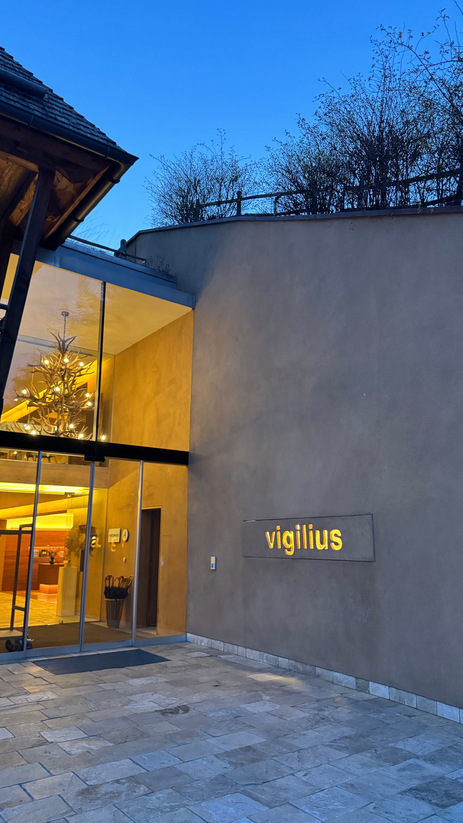 Vigilius Mountain Resort entrance at dusk, Lana South Tyrol